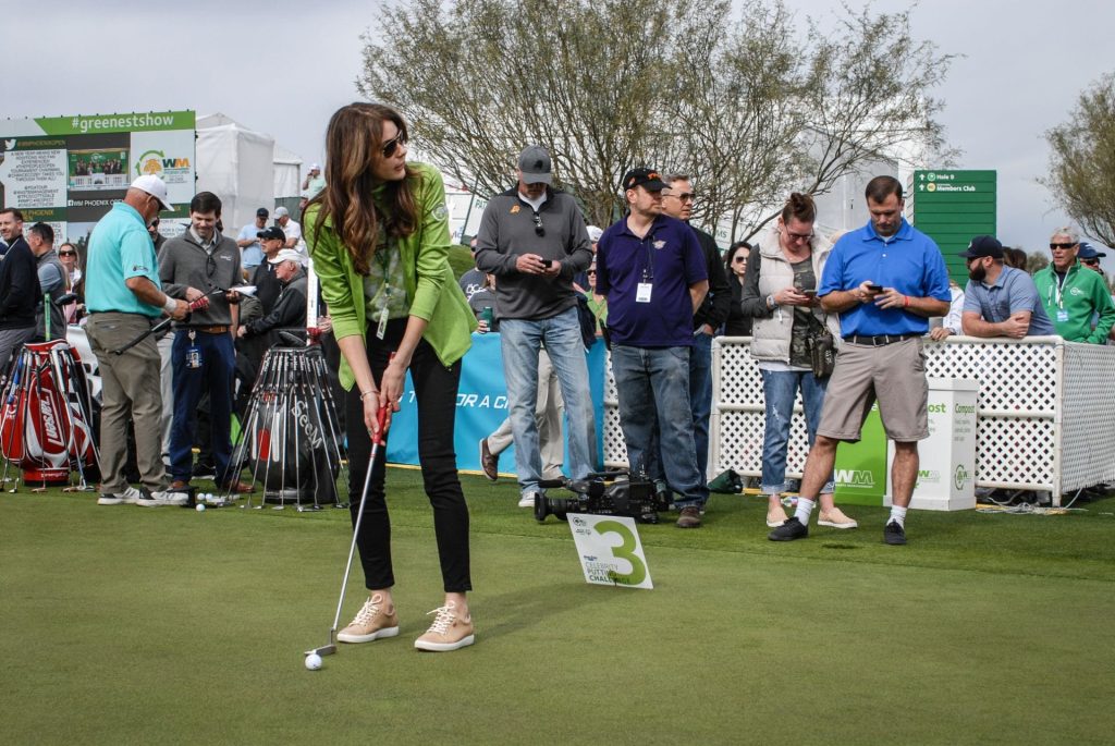 Celebrity putting challenge participant golfing